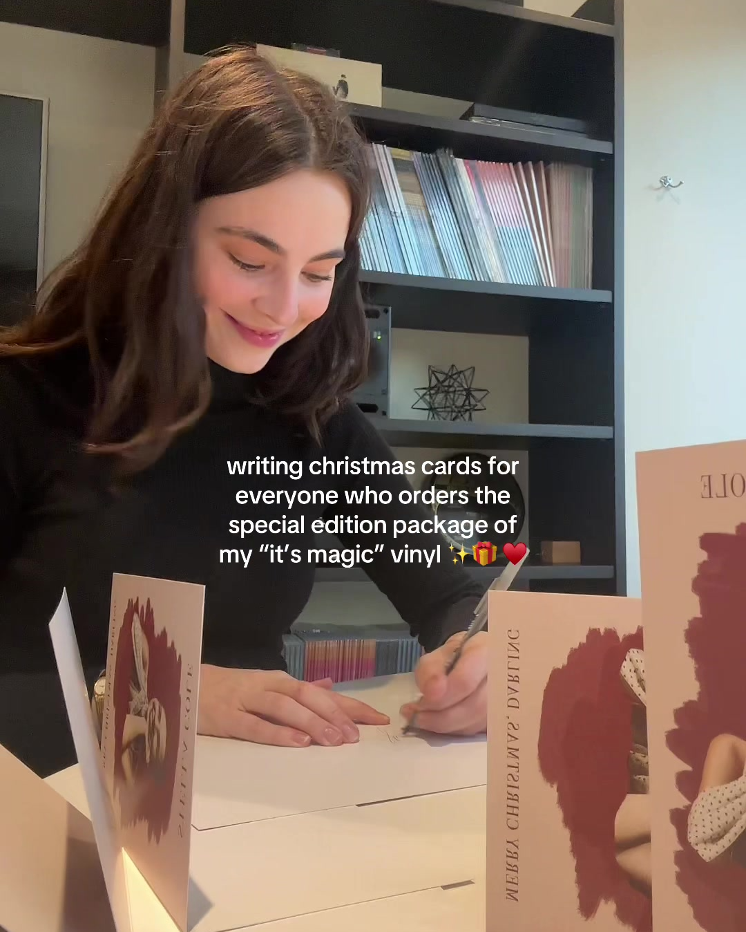 Singer Stella Cole signing Christmas cards to add to her product bundles